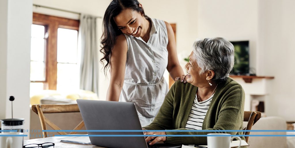 young woman with older woman on a laptop