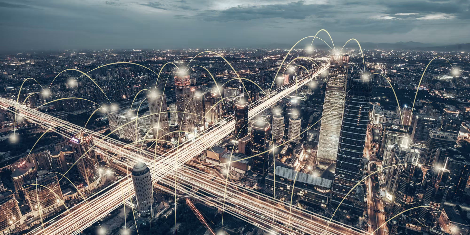 Drone image of city with slow shutter speed capturing light trails of cars