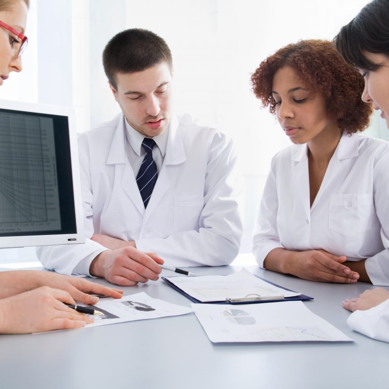 Four young doctors discussing a diagnosis