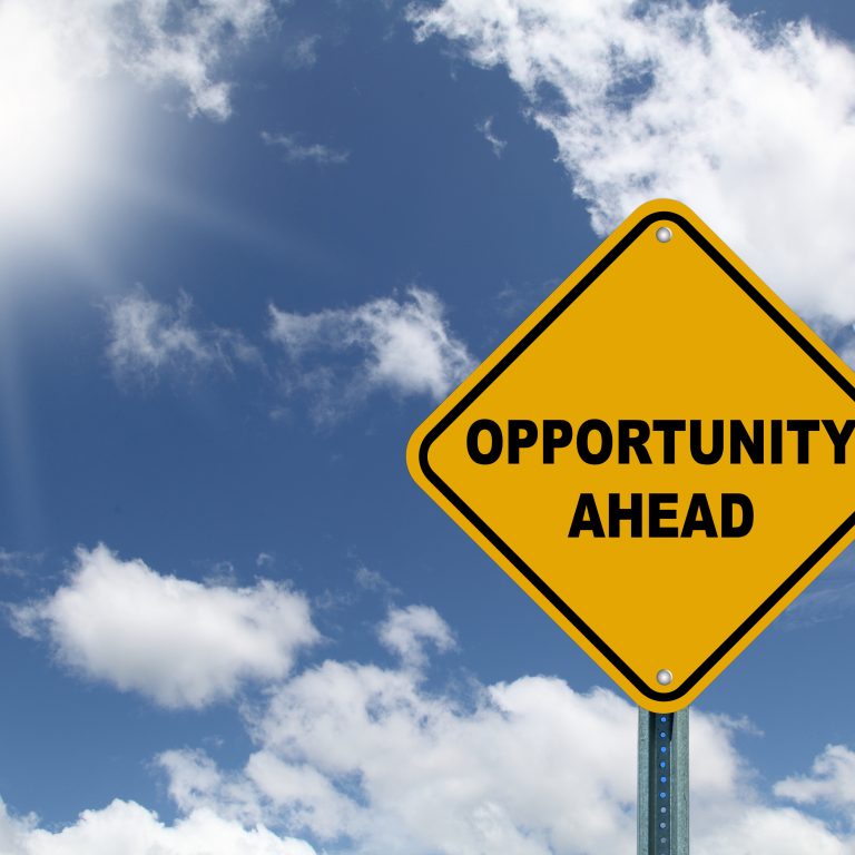 Yellow opportunity ahead road sign with sky